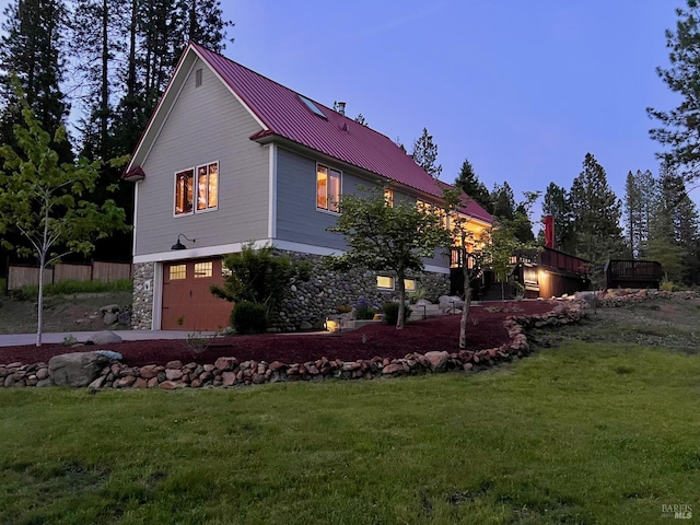 9 Spring Meadows Rd, Mccloud, CA 96507 - view of side of property with a garage, metal roof, stone siding, a standing seam roof, and a yard