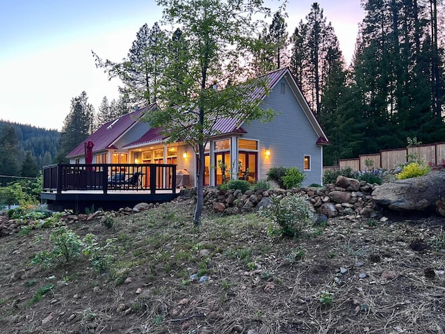 9 Spring Meadows Rd, Mccloud, CA 96507 - back of house at dusk with a wooden deck