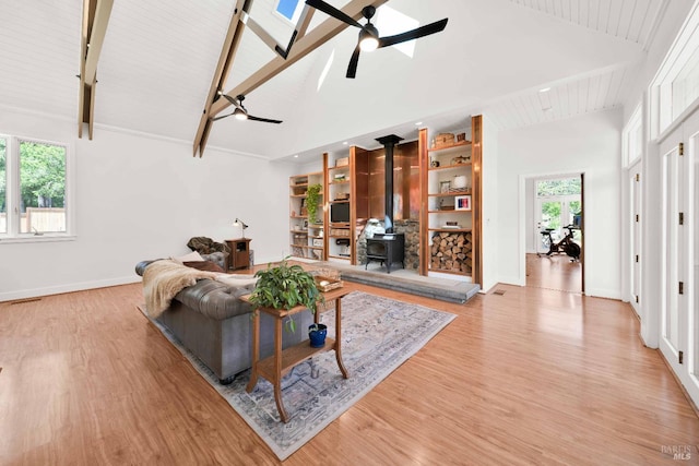 9 Spring Meadows Rd, Mccloud, CA 96507 - living area featuring a wood stove, ceiling fan, high vaulted ceiling, light wood-type flooring, and beam ceiling