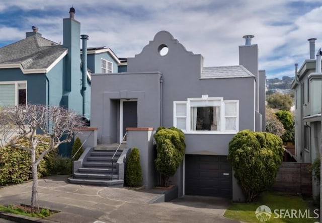 169 Forest Side Ave, San Francisco, CA 94127 - view of front facade with stucco siding, an attached garage, a chimney, driveway, and stairs