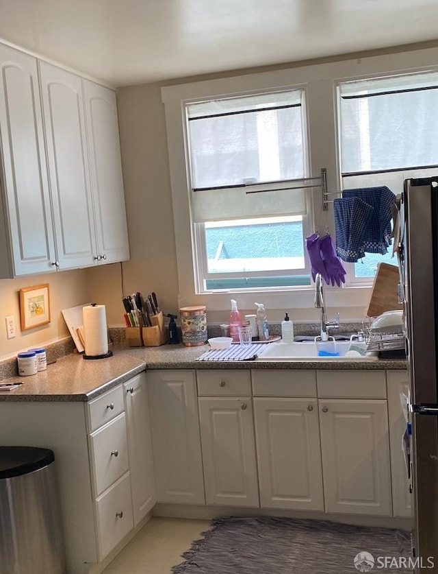 169 Forest Side Ave, San Francisco, CA 94127 - kitchen with white cabinets, freestanding refrigerator, and a sink