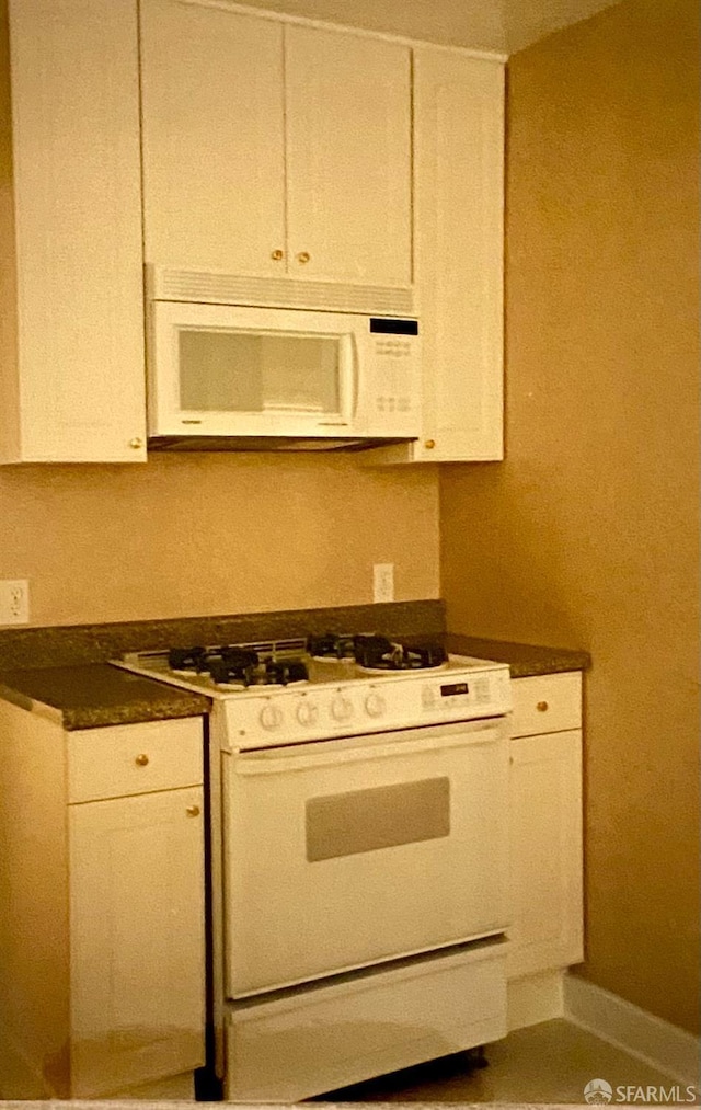 169 Forest Side Ave, San Francisco, CA 94127 - kitchen featuring white appliances, white cabinets, and dark countertops