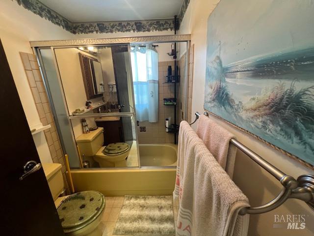 13238 Ebbtide Vlg, Clearlake Oaks, CA 95423 - bathroom with enclosed tub / shower combo, toilet, and tile patterned flooring