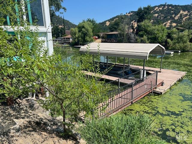 13238 Ebbtide Vlg, Clearlake Oaks, CA 95423 - view of yard featuring a floating dock, a carport, and a water and mountain view