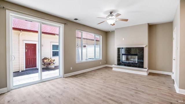 9149 Windsor Rd, Windsor, CA 95492 - unfurnished living room featuring light wood-style floors, a ceiling fan, and a fireplace