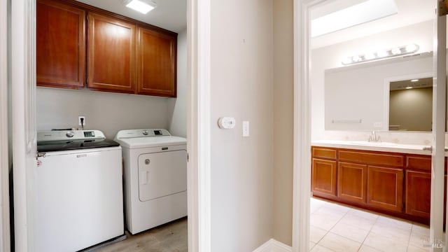 9149 Windsor Rd, Windsor, CA 95492 - washroom featuring independent washer and dryer, cabinet space, and light tile patterned flooring