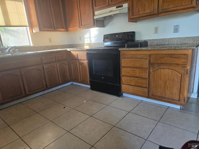 3 Greenfield Ct, Vallejo, CA 94590 - kitchen with black range with electric cooktop, under cabinet range hood, brown cabinetry, and light tile patterned floors