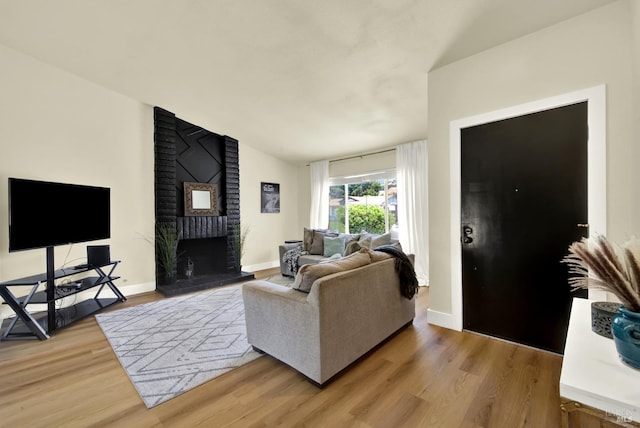 201 Pamela Ct, Vallejo, CA 94589 - living area with lofted ceiling, light wood finished floors, baseboards, and a fireplace
