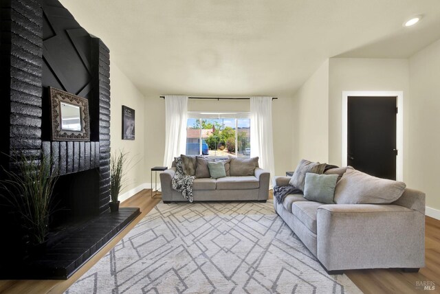 201 Pamela Ct, Vallejo, CA 94589 - living area featuring a brick fireplace, wood finished floors, baseboards, and recessed lighting