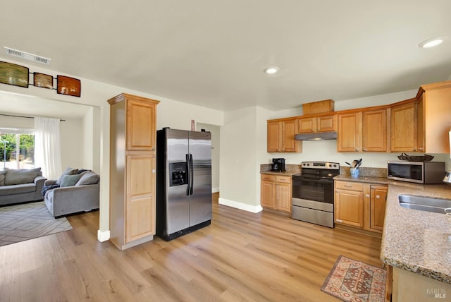 201 Pamela Ct, Vallejo, CA 94589 - kitchen with appliances with stainless steel finishes, under cabinet range hood, light wood-style flooring, light stone countertops, and recessed lighting