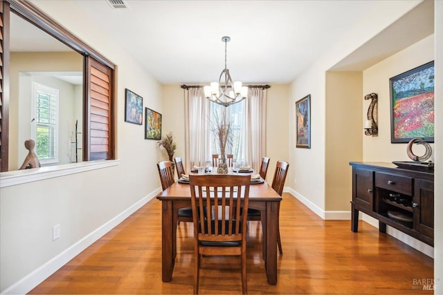 428 Lloyd Ct, Benicia, CA 94510 - dining area featuring a chandelier, wood finished floors, and baseboards