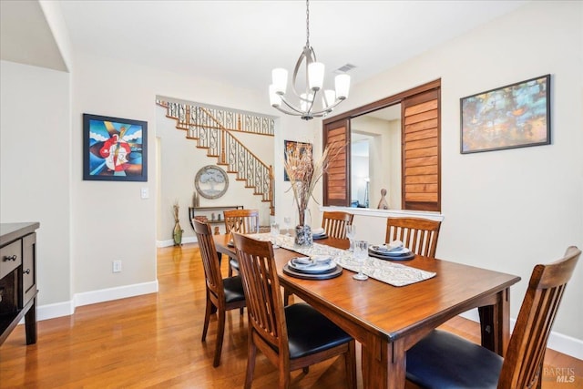 428 Lloyd Ct, Benicia, CA 94510 - dining room with a chandelier, light wood-type flooring, stairs, and baseboards