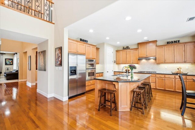 428 Lloyd Ct, Benicia, CA 94510 - kitchen featuring appliances with stainless steel finishes, baseboards, light wood finished floors, a sink, and recessed lighting