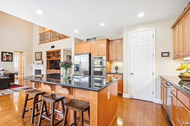 428 Lloyd Ct, Benicia, CA 94510 - kitchen with stainless steel appliances, a sink, light wood-style floors, open floor plan, and a breakfast bar area