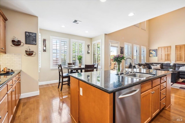 428 Lloyd Ct, Benicia, CA 94510 - kitchen with a sink, light wood finished floors, a kitchen island with sink, dark stone countertops, and open floor plan