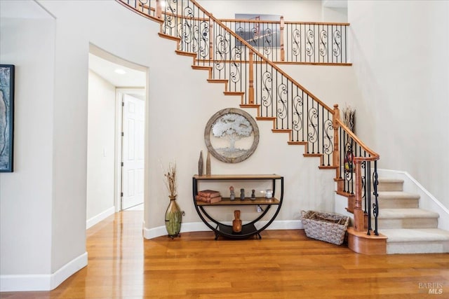 428 Lloyd Ct, Benicia, CA 94510 - stairs featuring wood finished floors, a towering ceiling, and baseboards