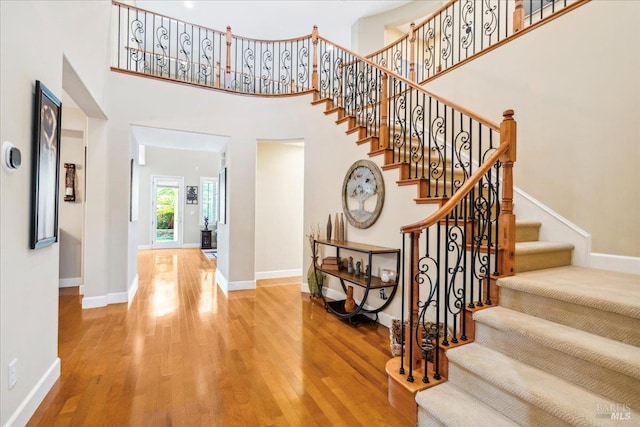 428 Lloyd Ct, Benicia, CA 94510 - entrance foyer featuring wood finished floors, stairway, baseboards, and a high ceiling