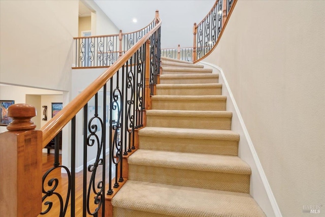 428 Lloyd Ct, Benicia, CA 94510 - stairway featuring wood finished floors, a towering ceiling, and baseboards