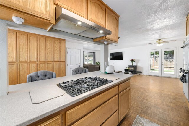 103 Quail Ct, Winters, CA 95694 - kitchen with open floor plan, under cabinet range hood, black gas cooktop, light countertops, and a ceiling fan