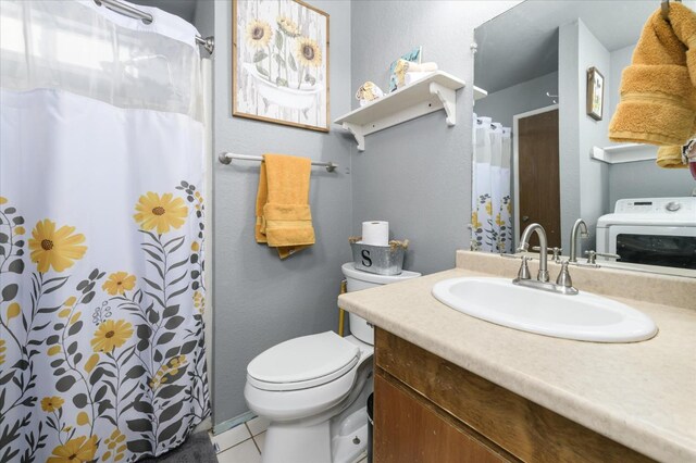 103 Quail Ct, Winters, CA 95694 - bathroom featuring washer / dryer, vanity, tile patterned flooring, toilet, and a shower with shower curtain