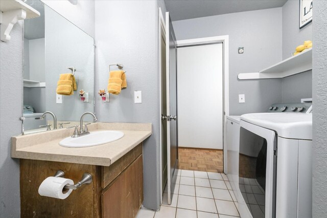 103 Quail Ct, Winters, CA 95694 - bathroom featuring washing machine and dryer and vanity