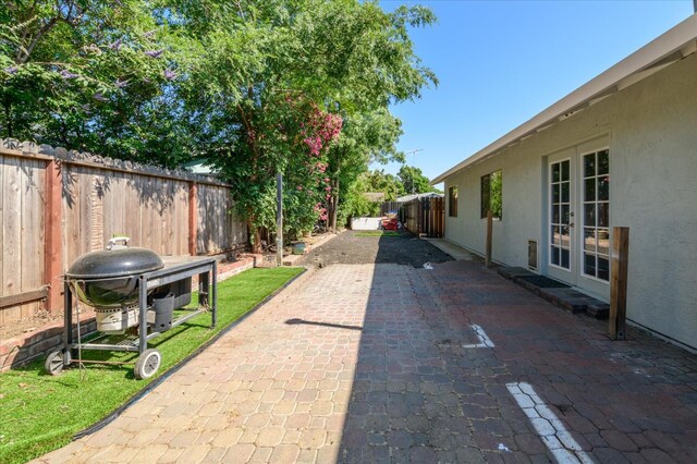 103 Quail Ct, Winters, CA 95694 - fenced backyard with a patio, area for grilling, and french doors