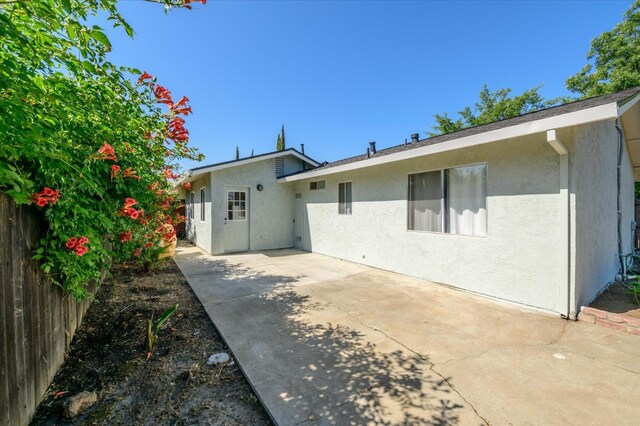 103 Quail Ct, Winters, CA 95694 - rear view of property featuring stucco siding and a patio area
