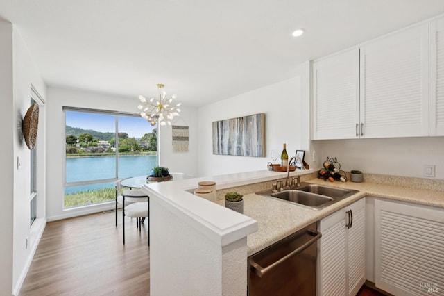 100 Lucky Dr Unit 109, Corte Madera, CA 94925 - kitchen with stainless steel dishwasher, a sink, white cabinets, wood finished floors, and recessed lighting