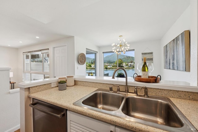 100 Lucky Dr Unit 109, Corte Madera, CA 94925 - kitchen with stainless steel dishwasher, a sink, a chandelier, recessed lighting, and light stone counters