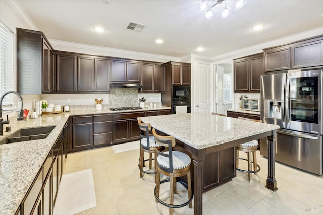5340 Discovery Way, Fairfield, CA 94533 - kitchen with black appliances, a sink, dark brown cabinets, a breakfast bar, and crown molding