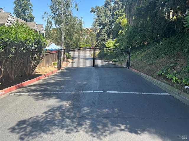 143 Sea Crest Cir, Vallejo, CA 94590 - view of asphalt street with curbs and a gate