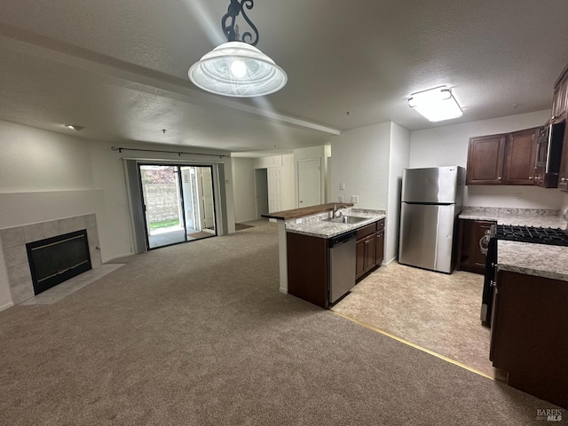 143 Sea Crest Cir, Vallejo, CA 94590 - kitchen featuring stainless steel appliances, open floor plan, a peninsula, dark brown cabinetry, and a textured ceiling