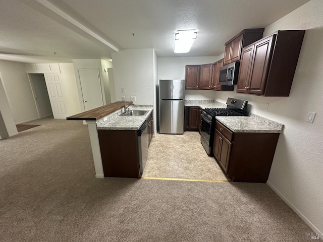 143 Sea Crest Cir, Vallejo, CA 94590 - kitchen featuring stainless steel appliances, a peninsula, light colored carpet, dark brown cabinetry, and open floor plan