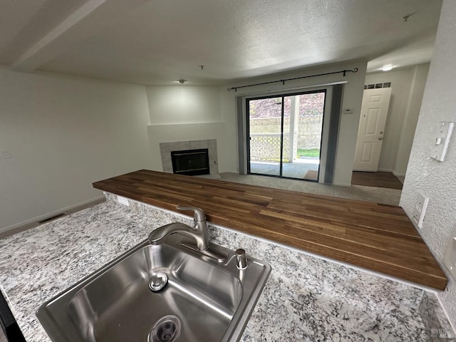 143 Sea Crest Cir, Vallejo, CA 94590 - kitchen featuring a sink, a fireplace, a textured ceiling, and open floor plan