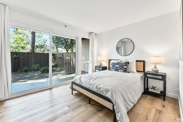 81 Forest Ln, San Rafael, CA 94903 - bedroom with access to outside, multiple windows, and wood finished floors