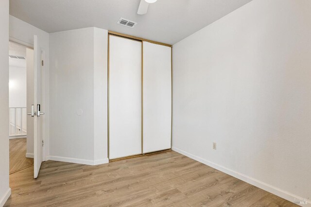 404 Mellowood Ct, Suisun City, CA 94585 - unfurnished bedroom with light wood finished floors, a closet, and ceiling fan