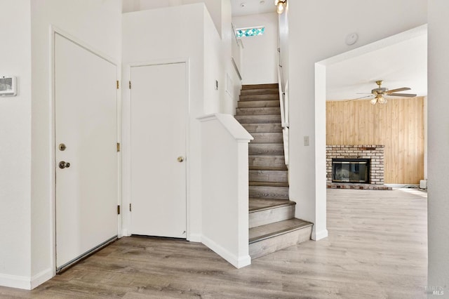 404 Mellowood Ct, Suisun City, CA 94585 - stairway with wood finished floors, a ceiling fan, and a brick fireplace