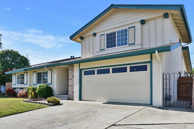 8567 Davona Dr, Dublin, CA 94568 - view of front of house featuring board and batten siding, concrete driveway, an attached garage, a front lawn, and stone siding