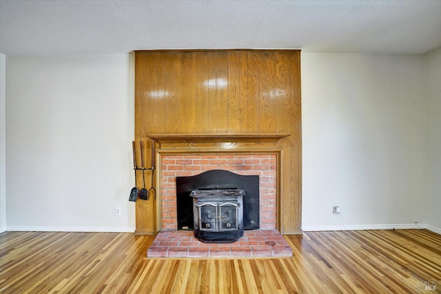 8567 Davona Dr, Dublin, CA 94568 - detailed view of a wood stove, wood finished floors, and a textured ceiling