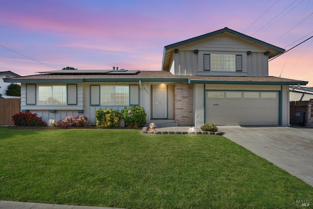 8567 Davona Dr, Dublin, CA 94568 - view of front of house with board and batten siding, concrete driveway, an attached garage, and solar panels