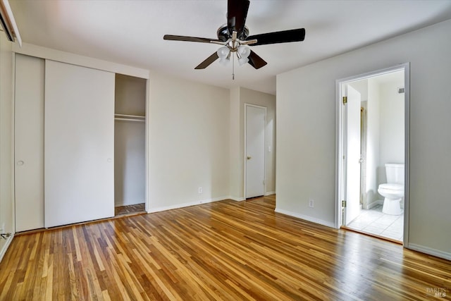 8567 Davona Dr, Dublin, CA 94568 - unfurnished bedroom with wood finished floors, a closet, connected bathroom, and a ceiling fan