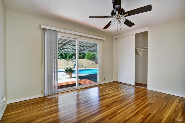 8567 Davona Dr, Dublin, CA 94568 - unfurnished bedroom with access to exterior, wood finished floors, a closet, and a ceiling fan