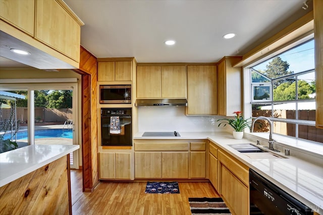 8567 Davona Dr, Dublin, CA 94568 - kitchen with black appliances, light countertops, light wood-style floors, light brown cabinets, and recessed lighting
