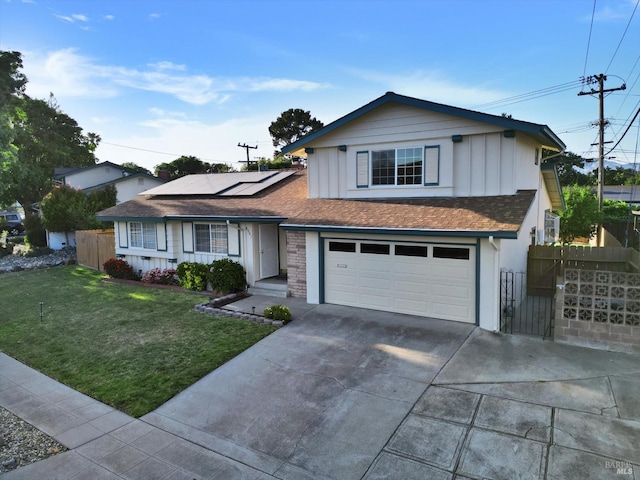 8567 Davona Dr, Dublin, CA 94568 - view of front facade with board and batten siding, roof mounted solar panels, concrete driveway, and a garage