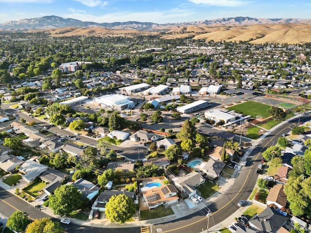 8567 Davona Dr, Dublin, CA 94568 - aerial view of property's location featuring a mountain backdrop and nearby suburban area