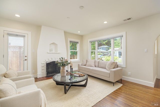 210 San Francisco Blvd, San Anselmo, CA 94960 - living area with a large fireplace, wood finished floors, recessed lighting, and arched walkways