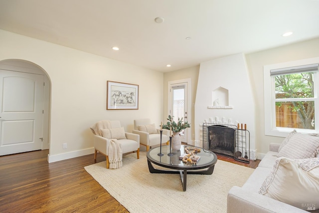 210 San Francisco Blvd, San Anselmo, CA 94960 - living area with healthy amount of natural light, a large fireplace, dark wood-style floors, arched walkways, and recessed lighting