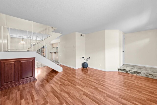 4014 Knoll Top Ct, Carmichael, CA 95608 - unfurnished living room featuring light wood-style flooring, stairs, and a chandelier