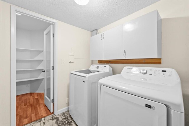 4014 Knoll Top Ct, Carmichael, CA 95608 - laundry room with cabinet space, washer and dryer, a textured ceiling, and light wood-style floors