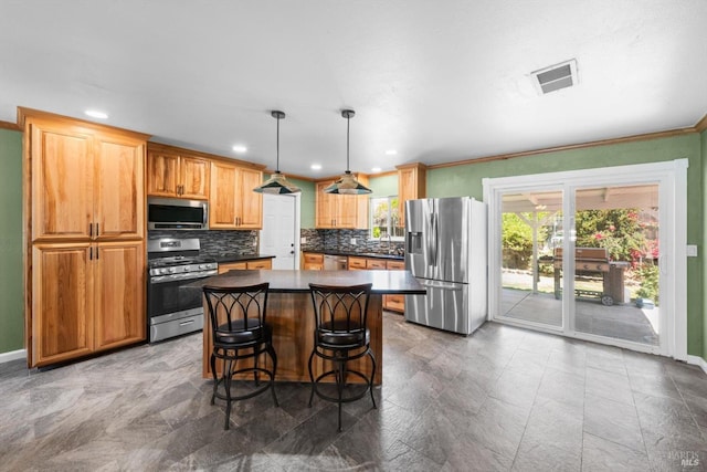 216 Walnut St, Suisun City, CA 94585 - kitchen featuring appliances with stainless steel finishes, dark countertops, tasteful backsplash, a center island, and ornamental molding